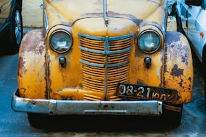 yellow vintage car with white and black eyes