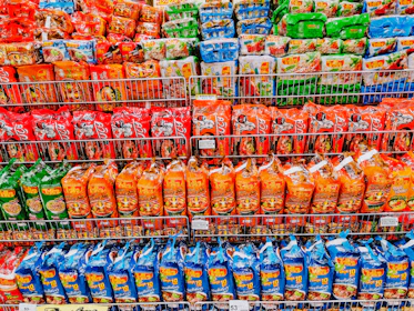 Rows of packaged instant noodle products ready for export in a bright warehouse.