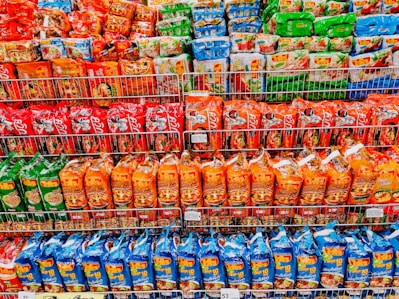 A variety of ready-to-eat meal packages on a shelf.