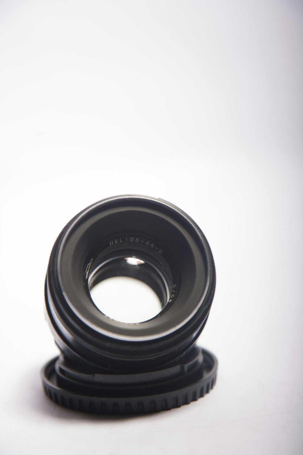 black camera lens on white surface
