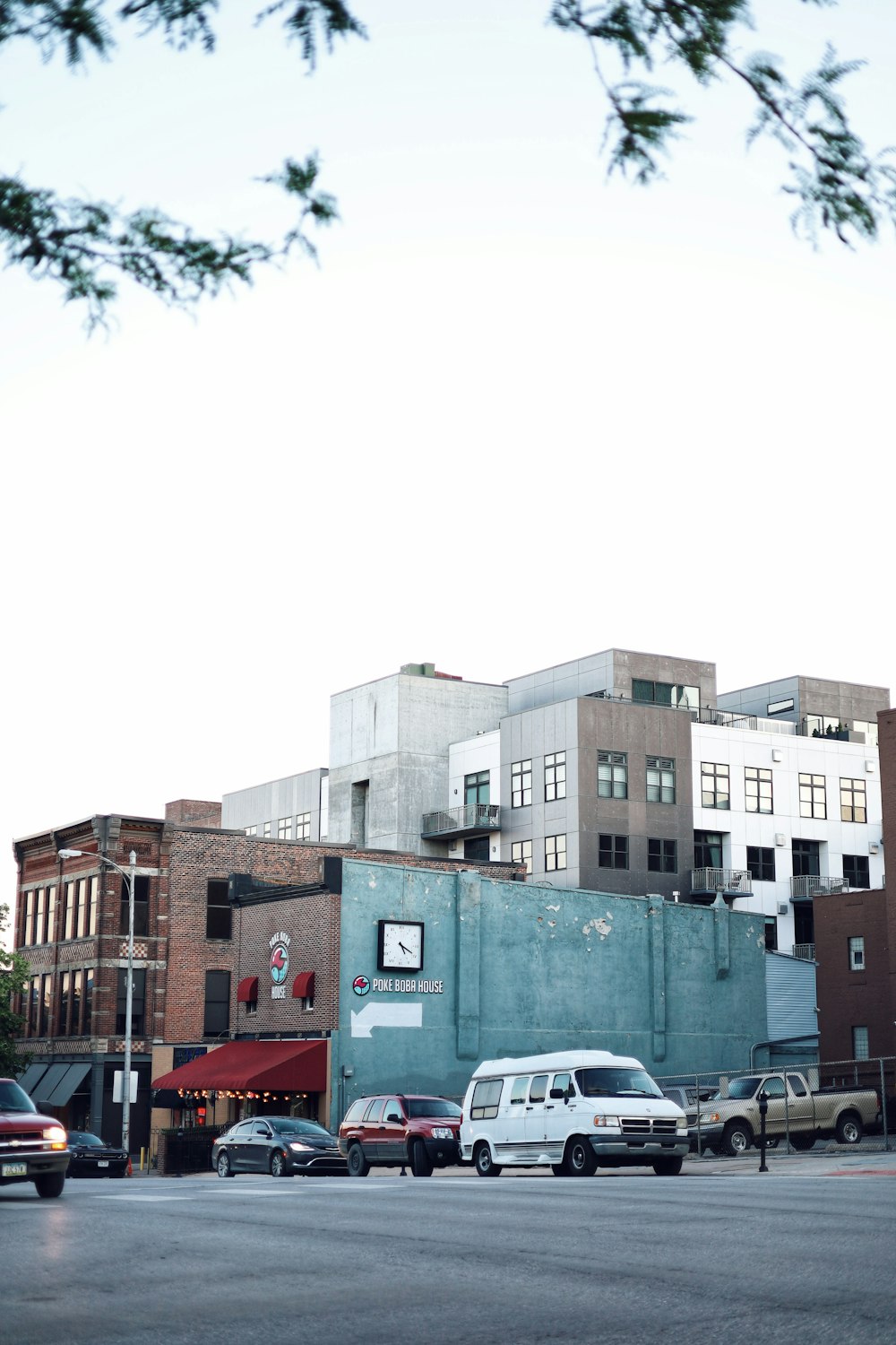 cars parked beside brown concrete building during daytime