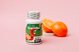 orange juice bottle beside orange fruit