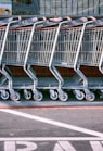 red and silver shopping cart on gray asphalt road during daytime