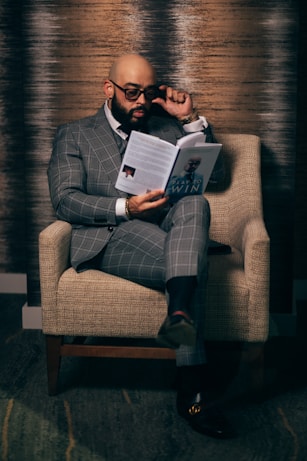woman in gray blazer sitting on brown sofa chair