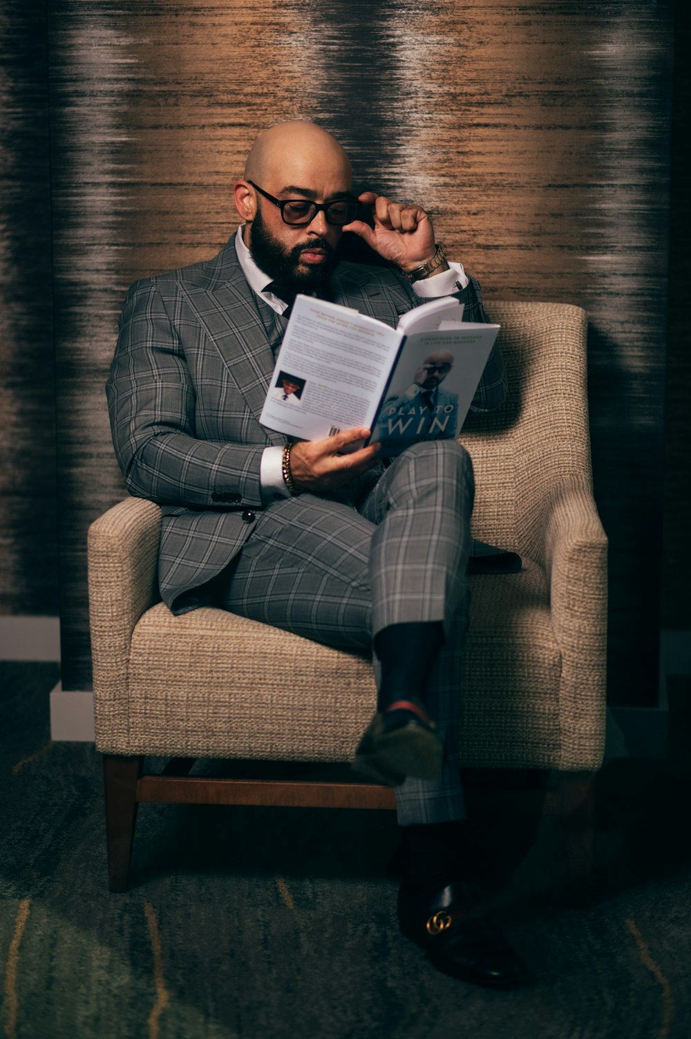 woman in gray blazer sitting on brown sofa chair