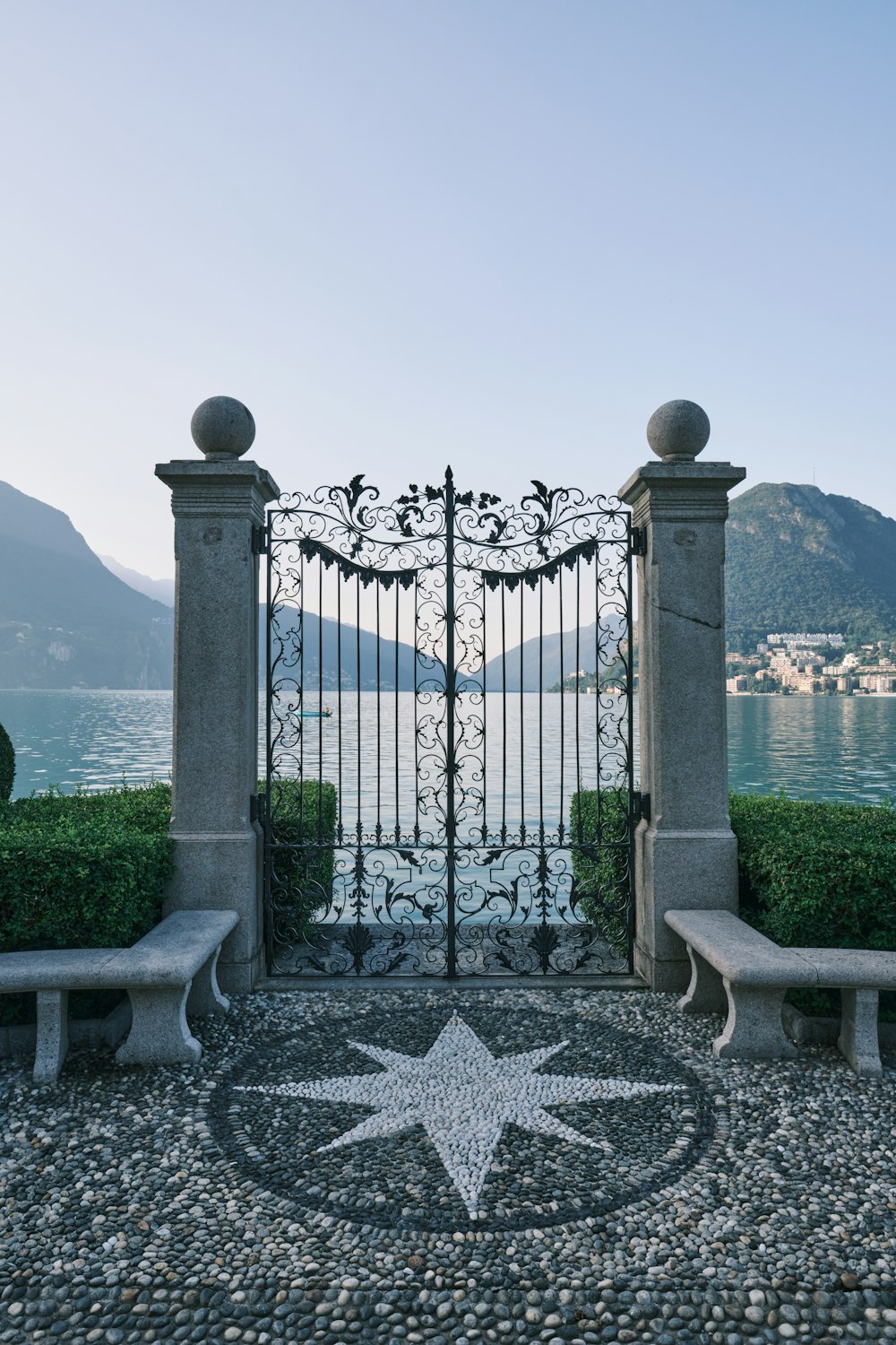 black metal gate near body of water during daytime