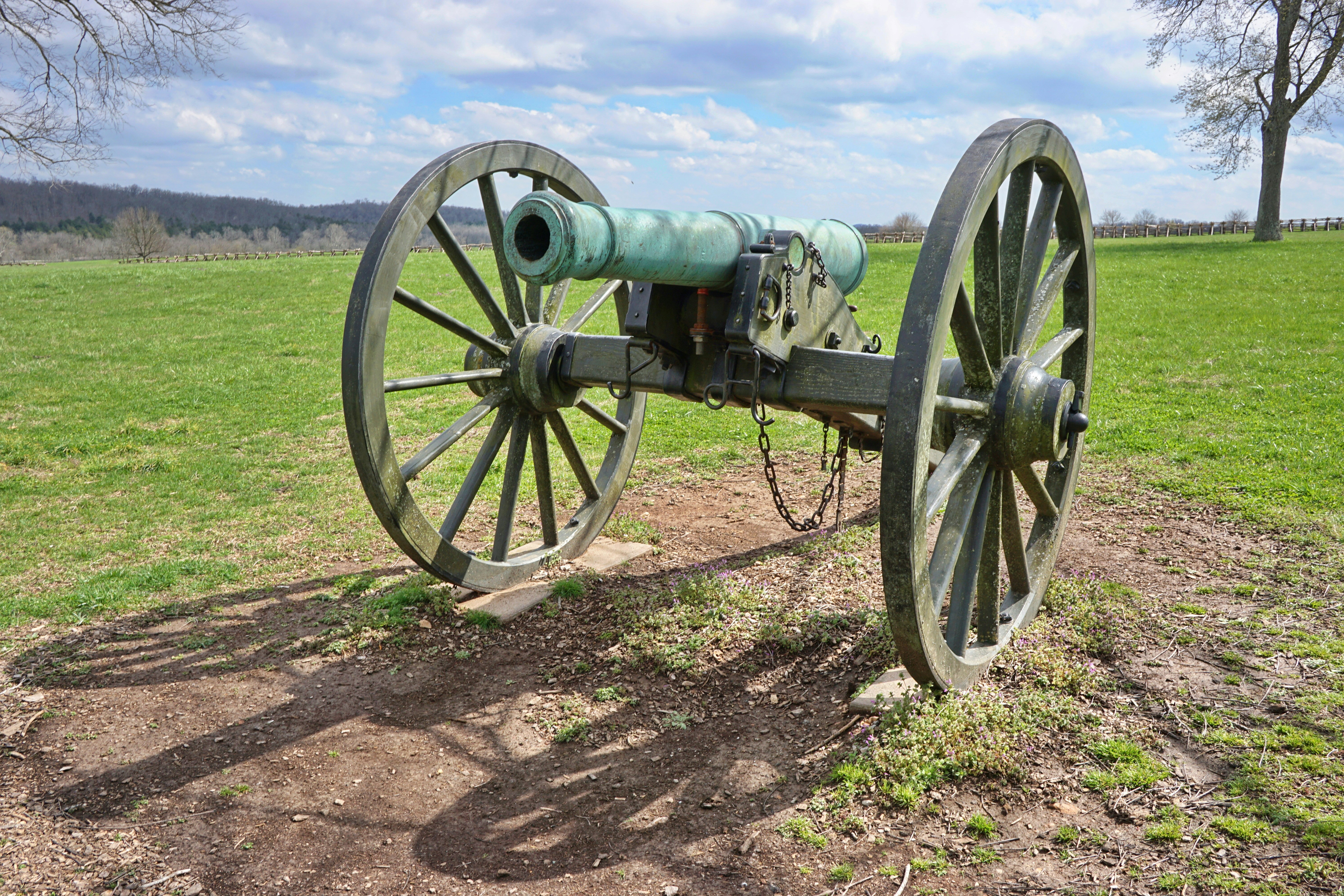 green and black metal wheel on brown soil