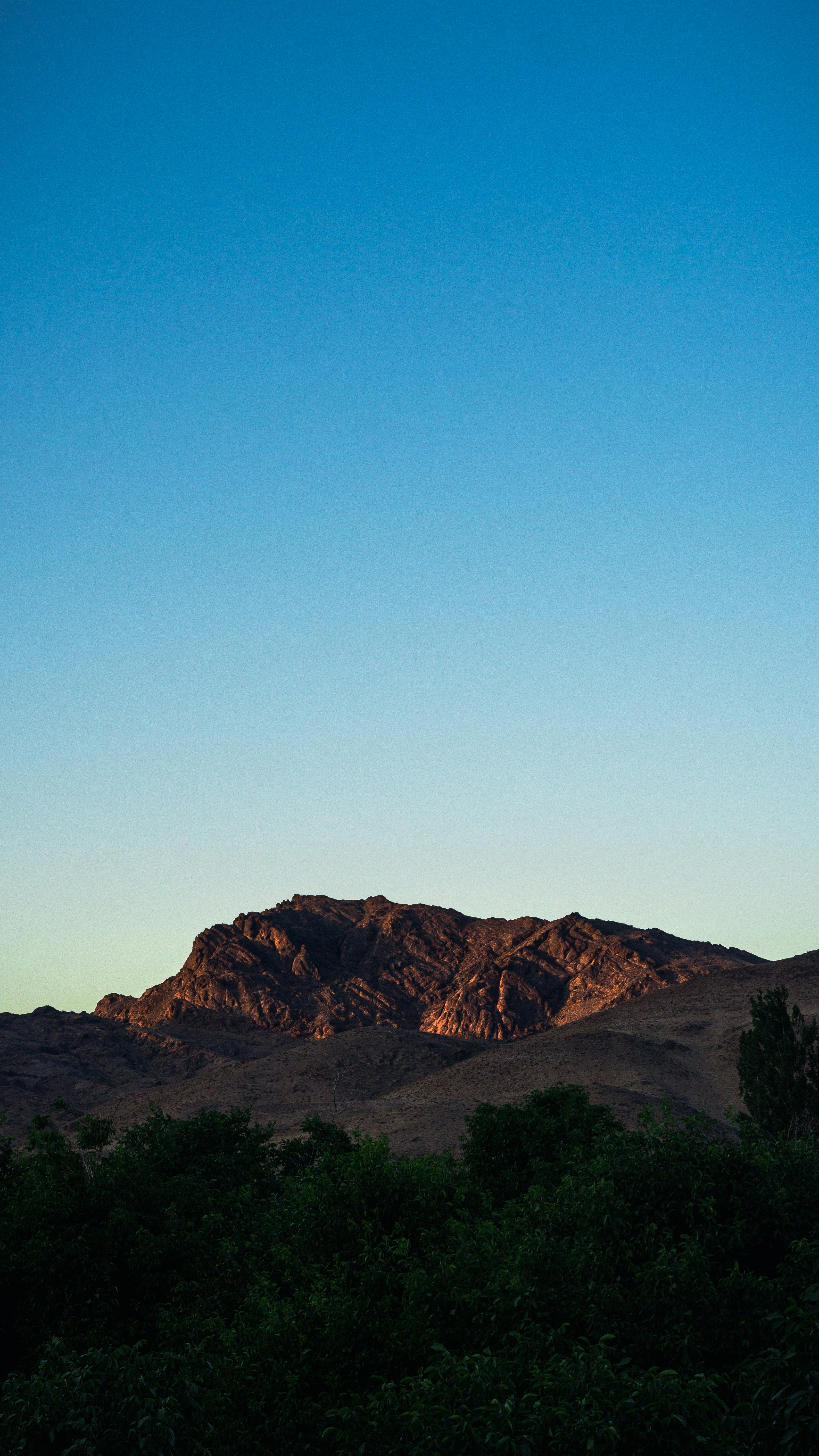 brown mountain under blue sky during daytime