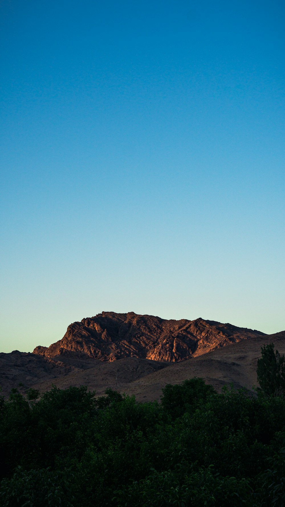 brown mountain under blue sky during daytime