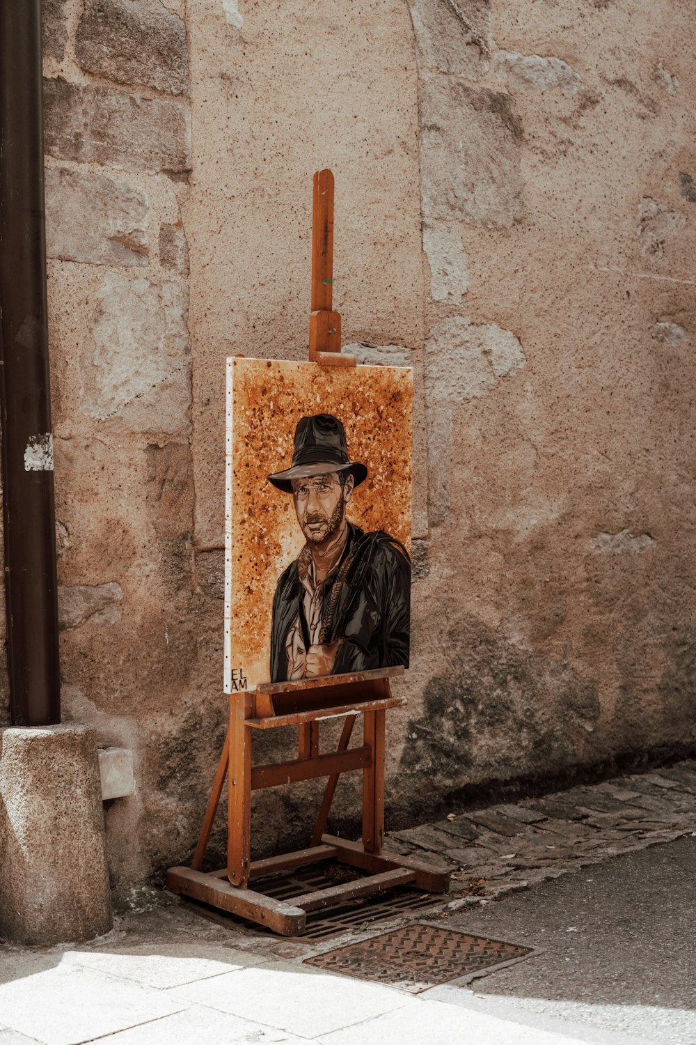 man in black jacket sitting on brown wooden chair