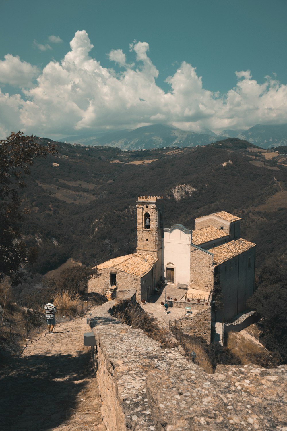 brown concrete building on mountain