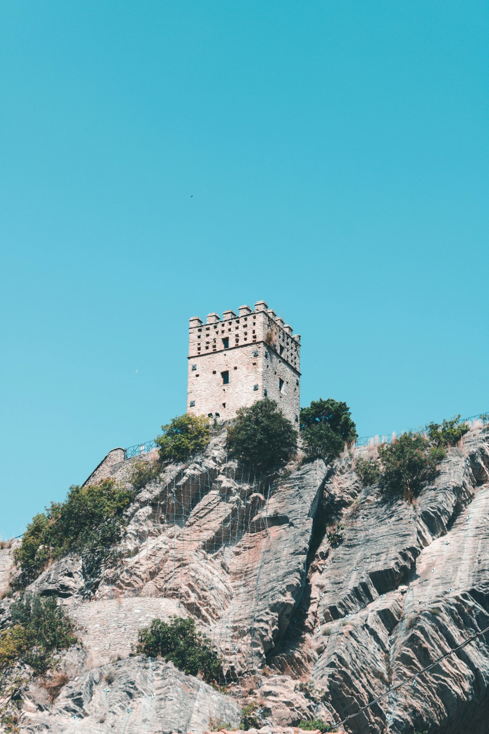 gray concrete building on cliff during daytime