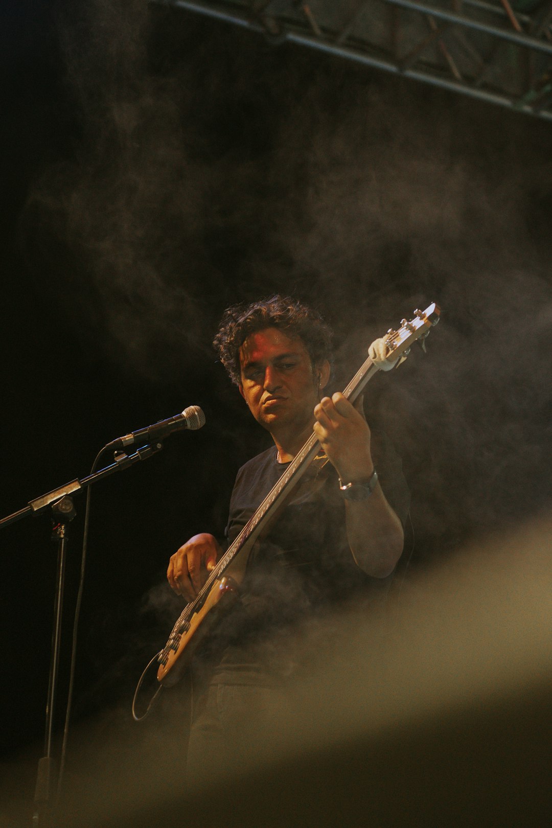 man in black shirt playing guitar