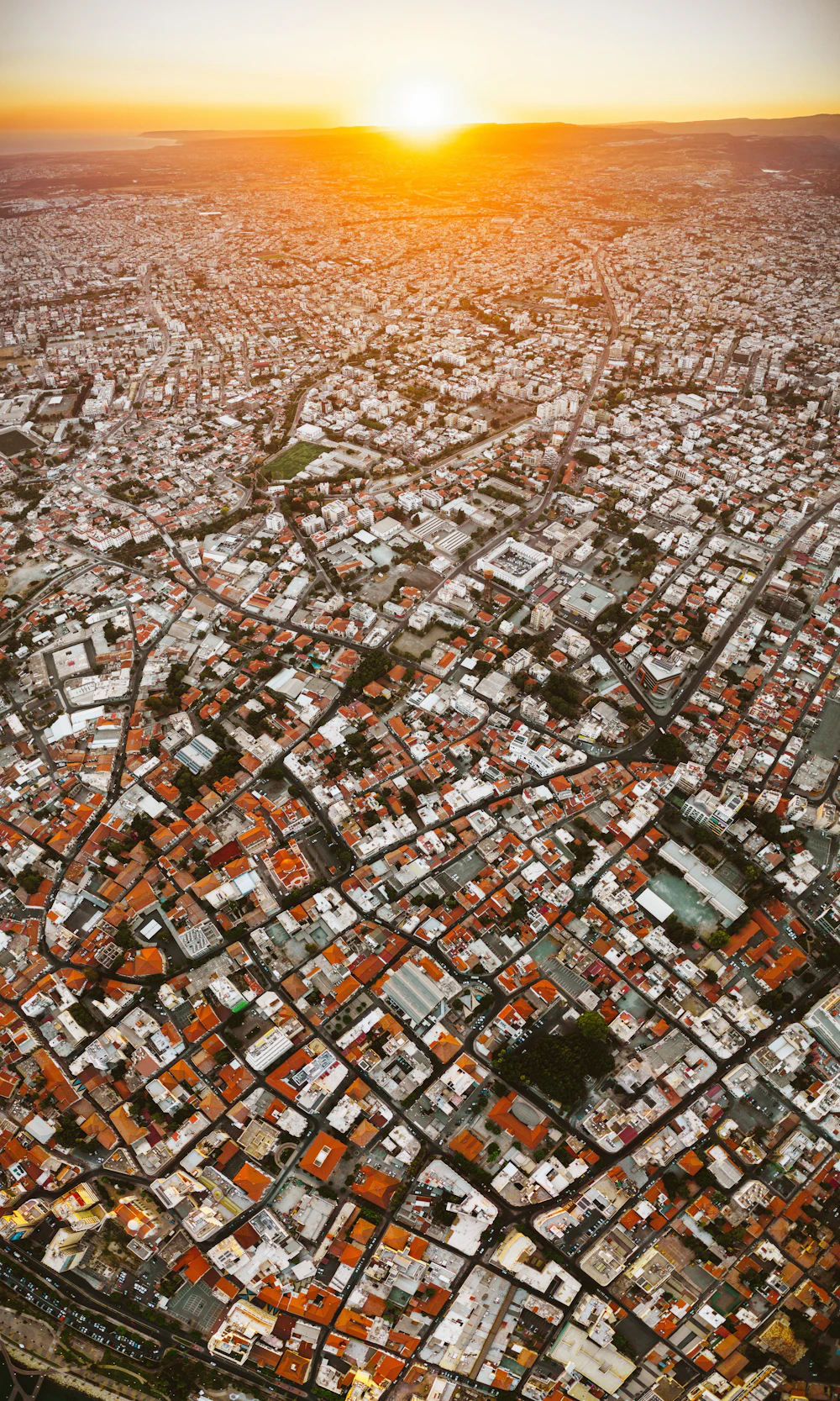 Aerial sunset over Limassol rooftops and coastline