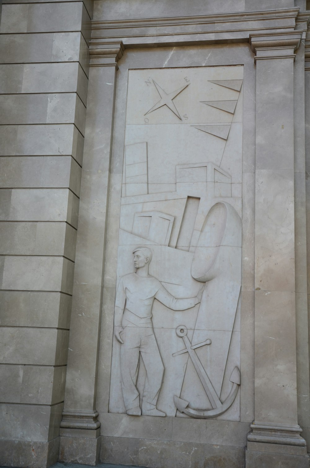 white concrete wall with human face carved