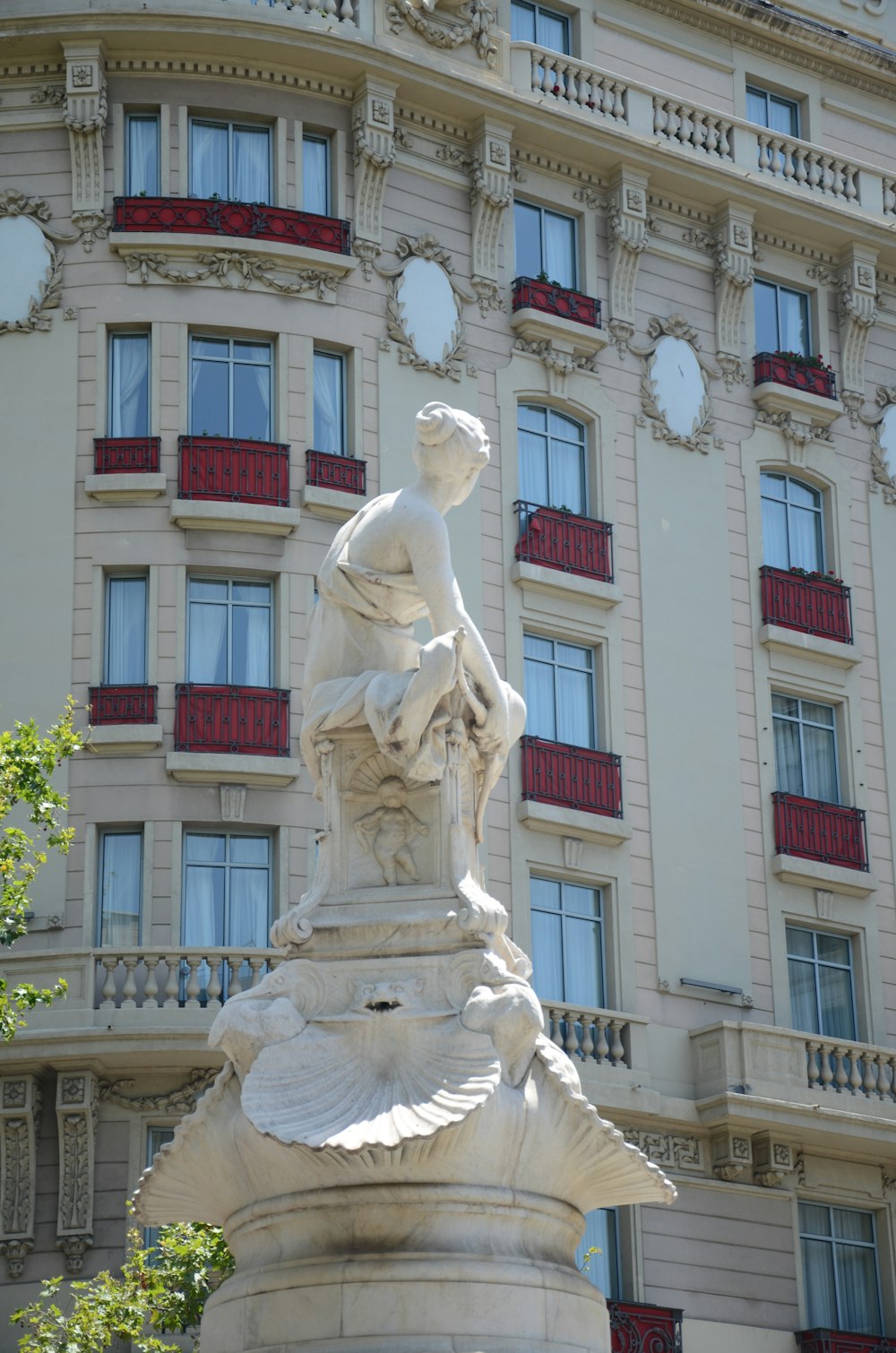 white concrete statue of man holding book