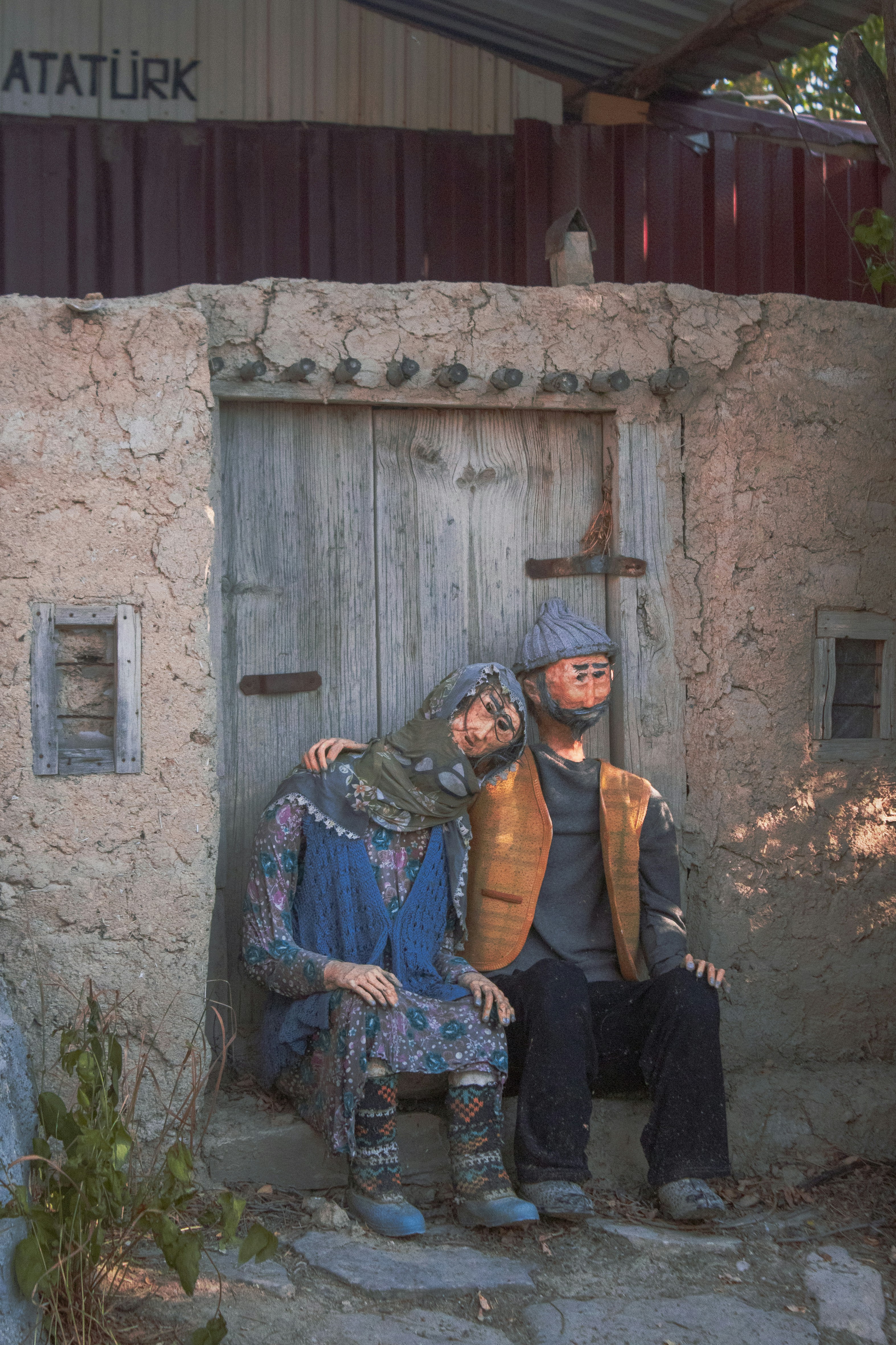 2 women standing beside brown concrete building during daytime