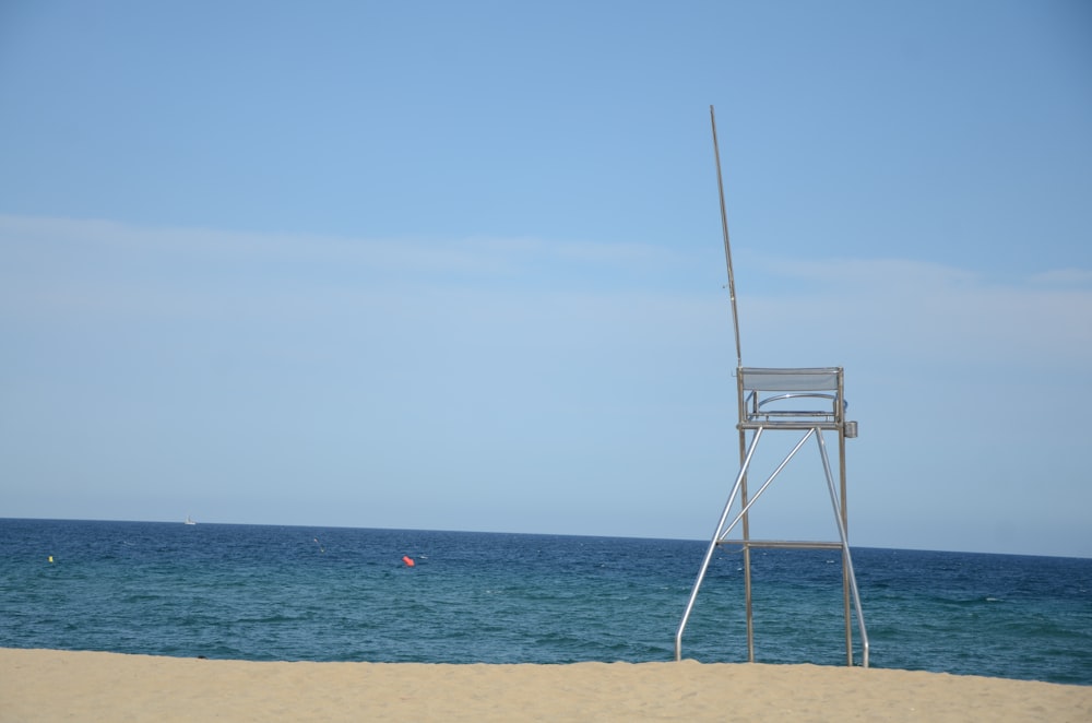 white wooden lifeguard tower on beach during daytime