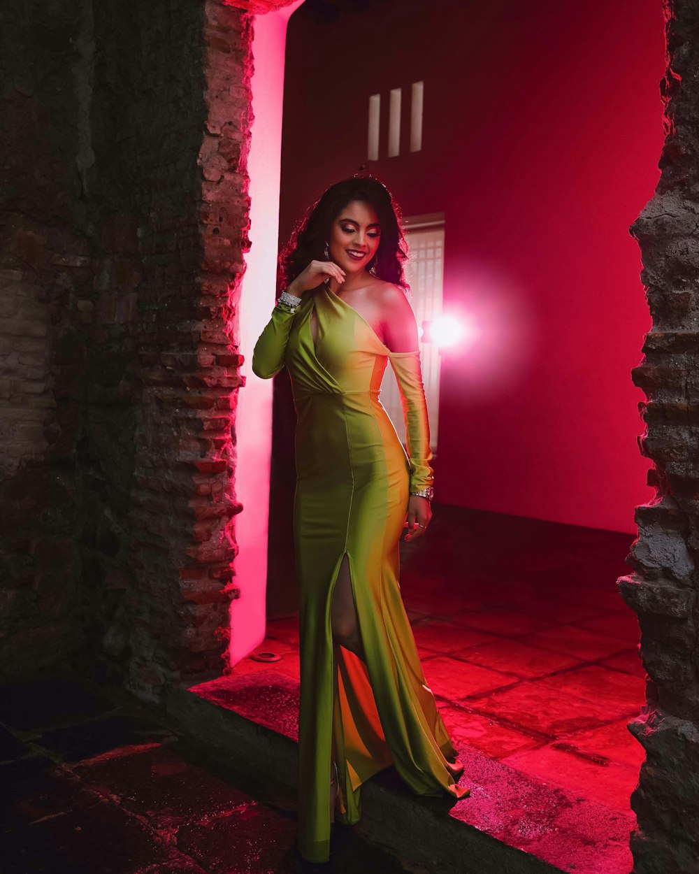 woman in green dress standing on red floor