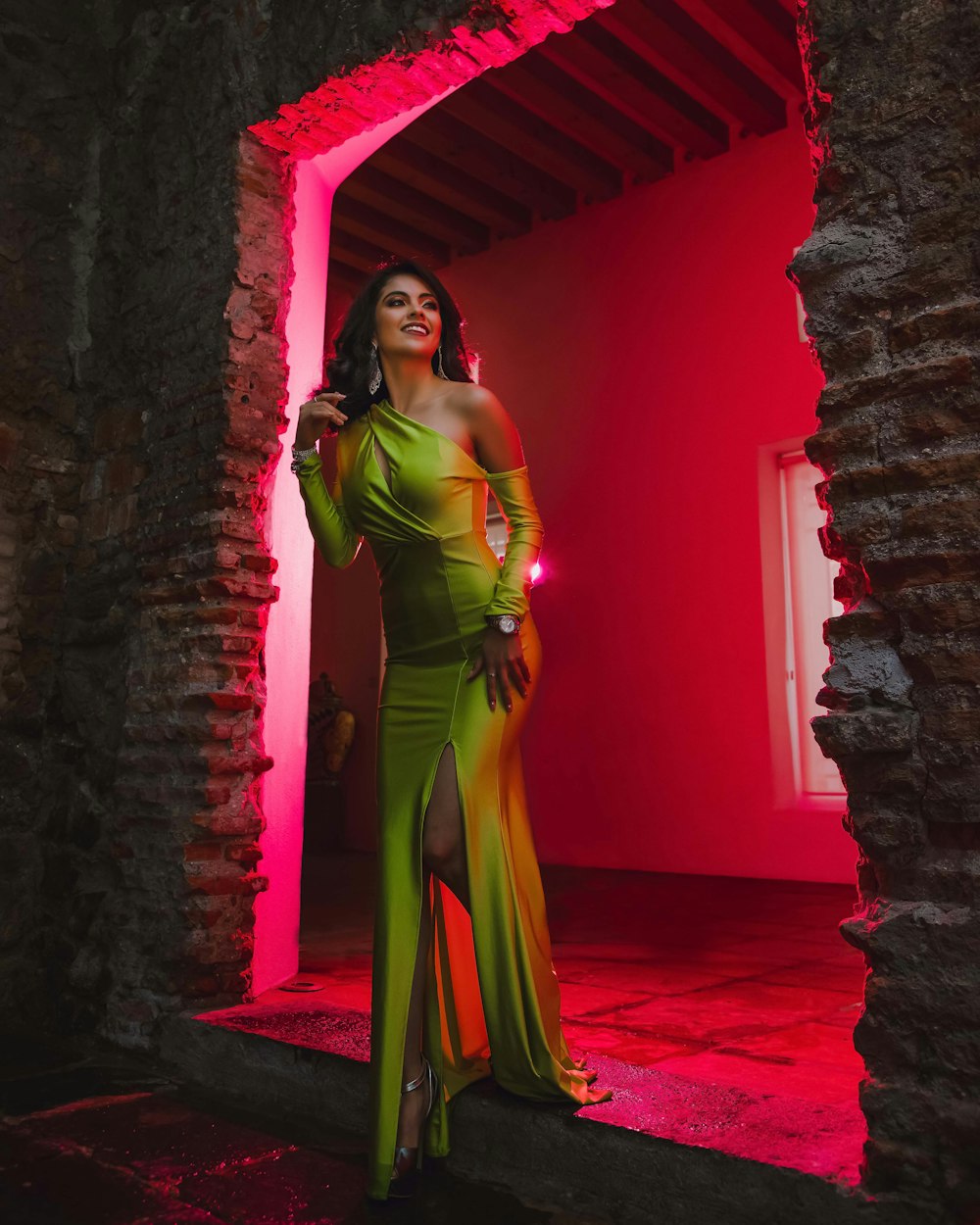 woman in green dress standing on red carpet