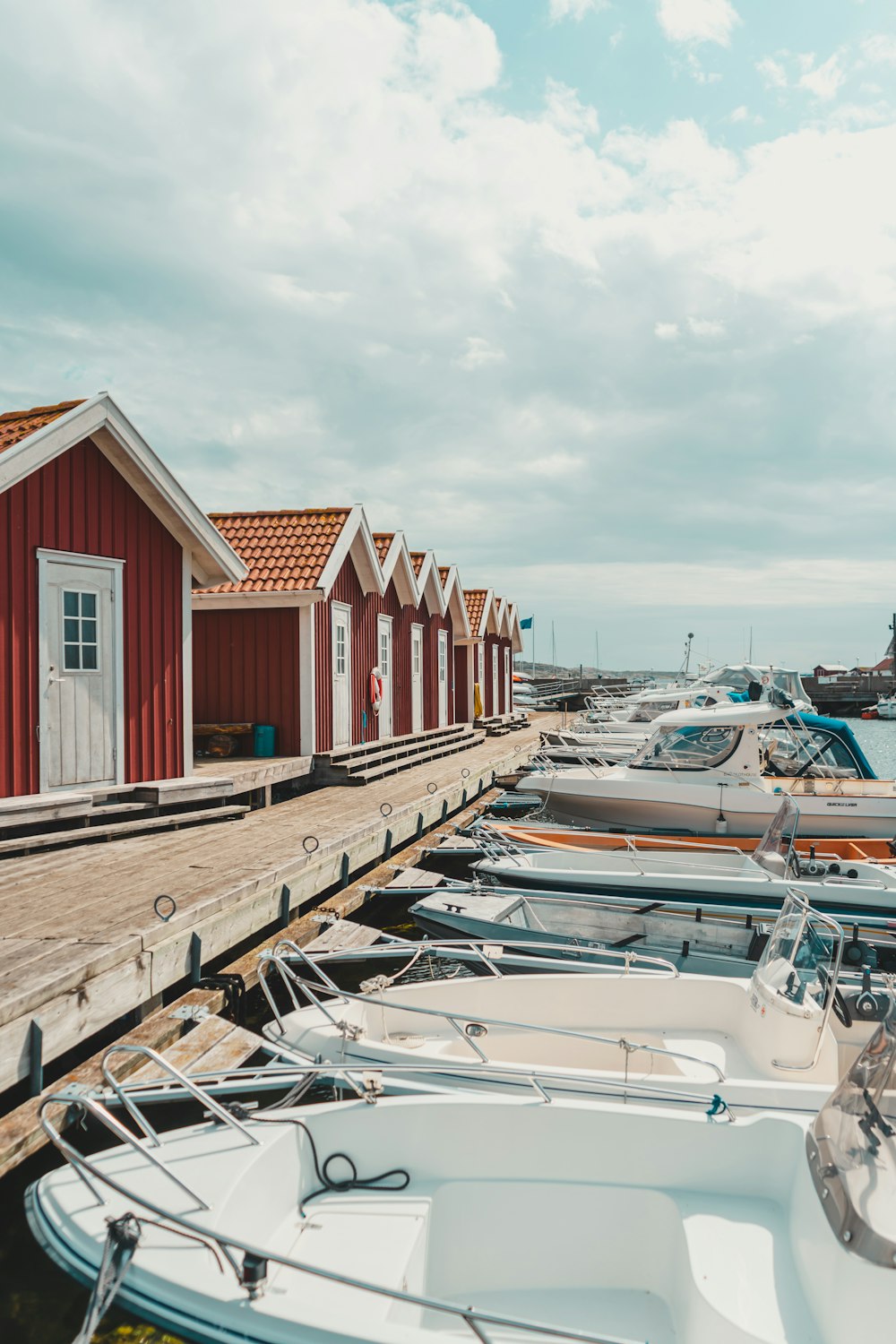 red and white wooden houses near body of water during daytime