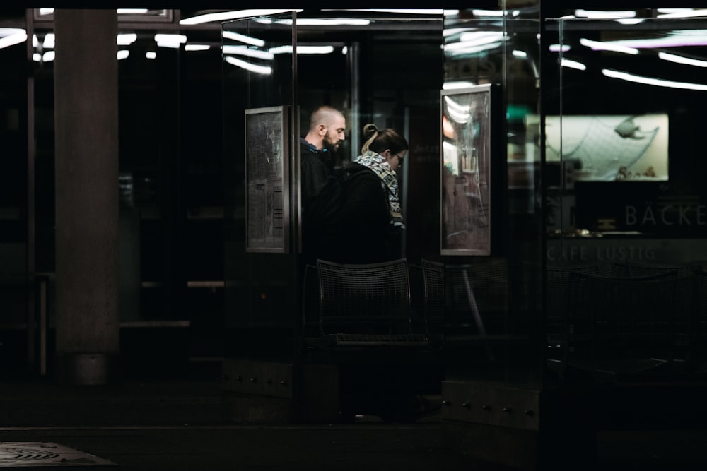 man in black jacket sitting on black chair