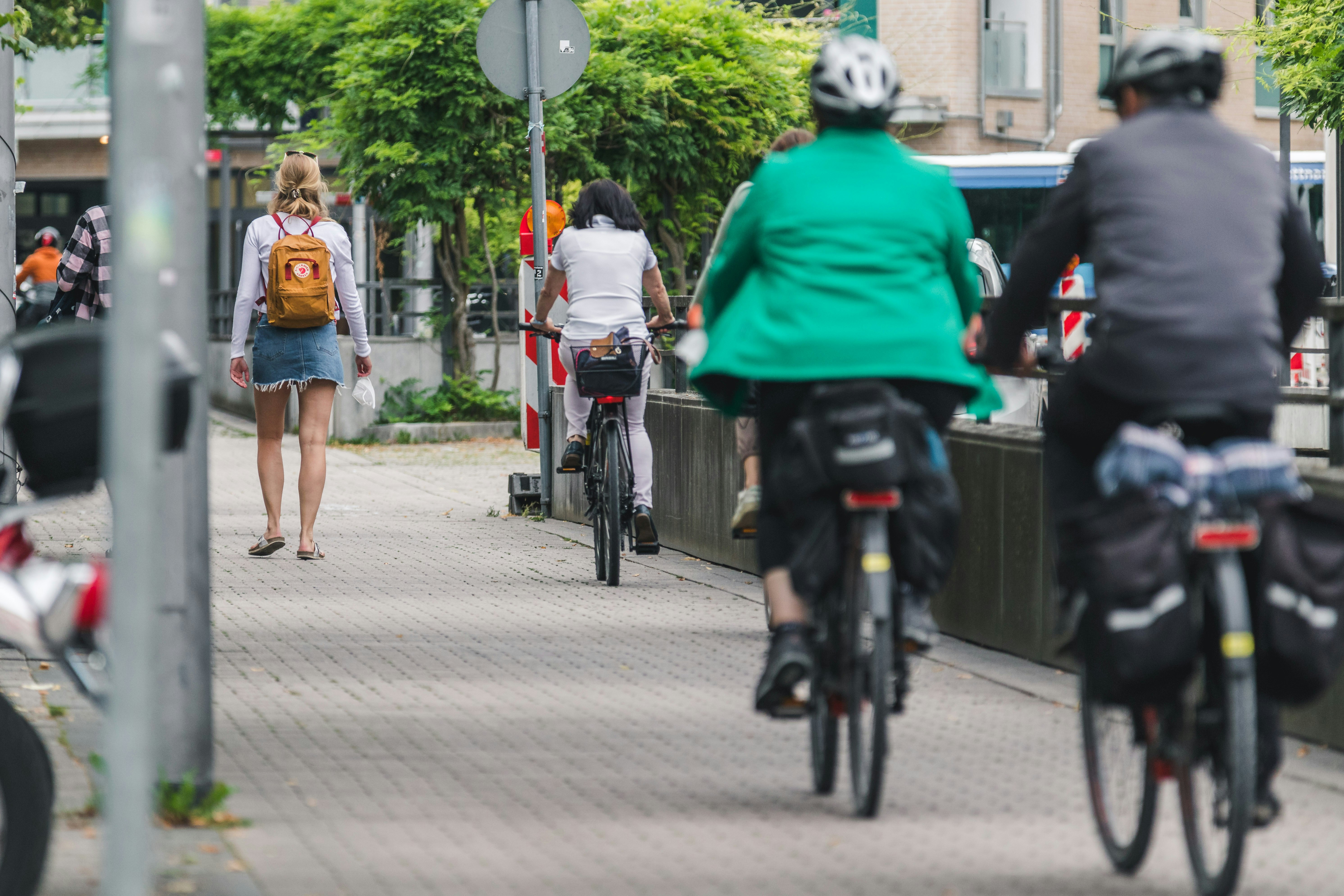 people riding bicycle on road during daytime