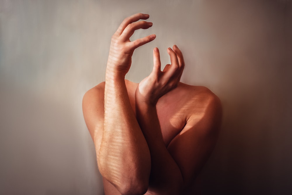 persons feet on white wall