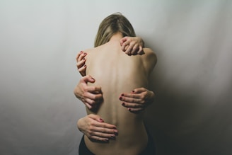 woman in black tank top covering her face