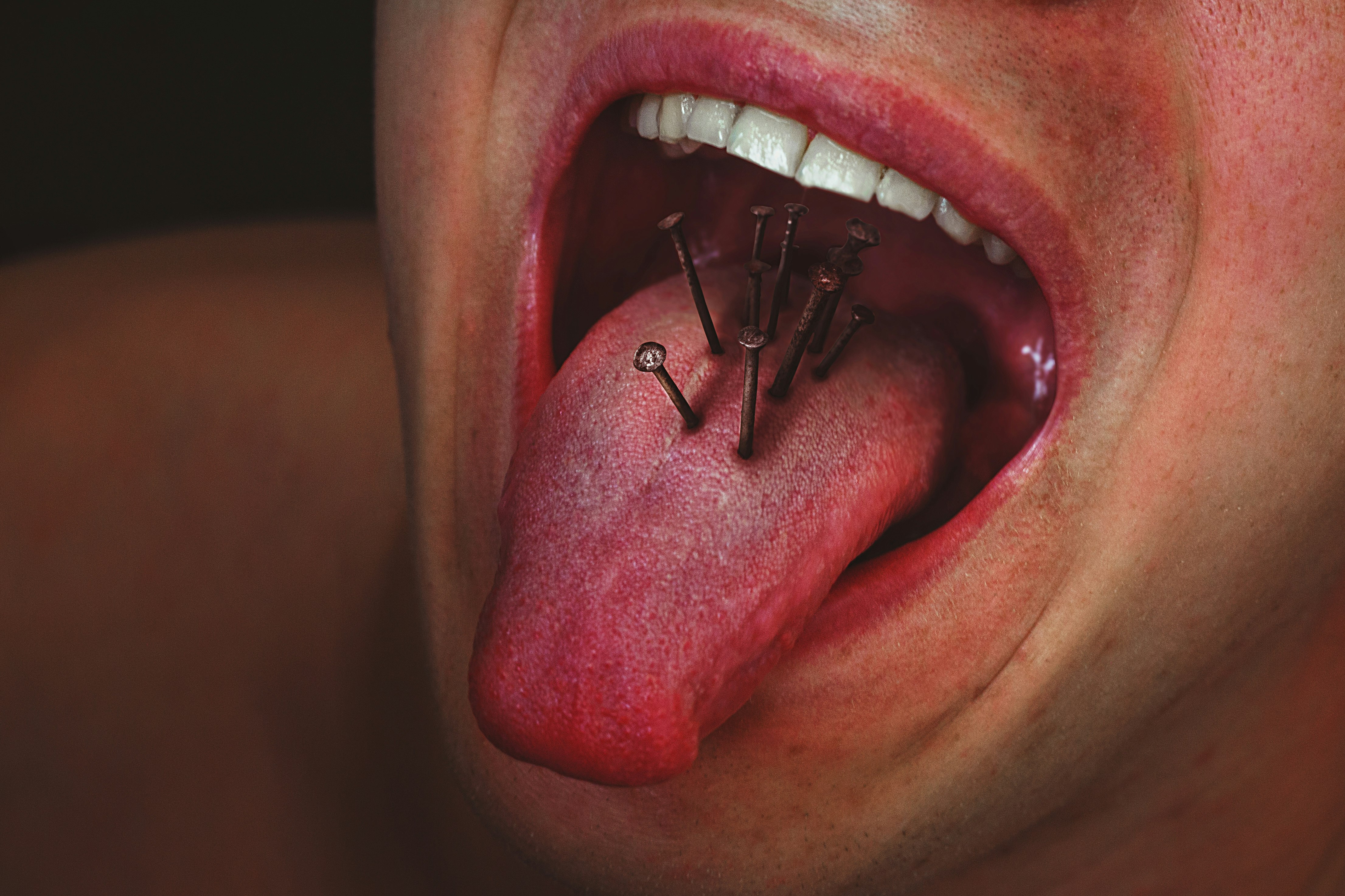 person with tongue out in mouth