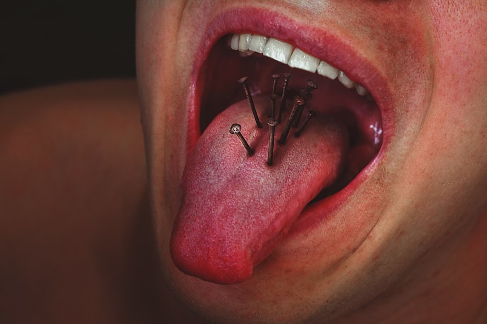 person with tongue out in mouth