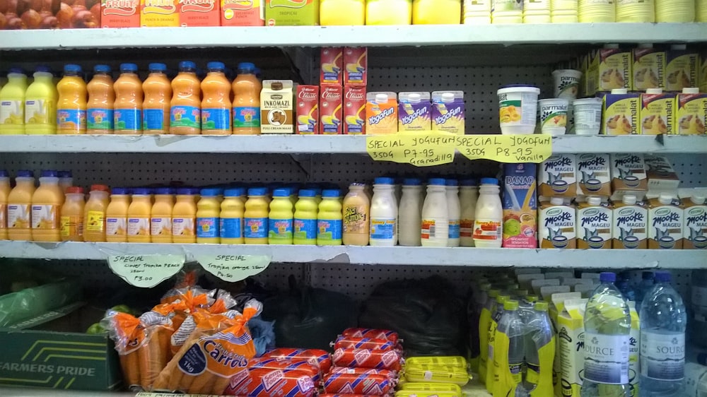 yellow and white plastic bottle on yellow shelf