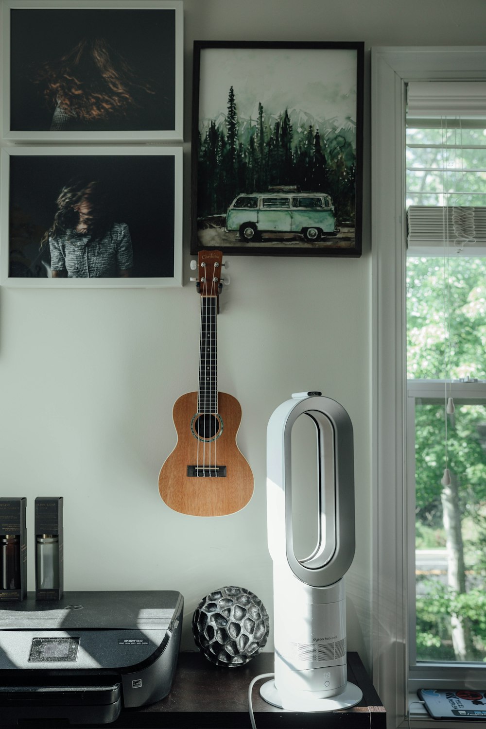 brown acoustic guitar on white wall