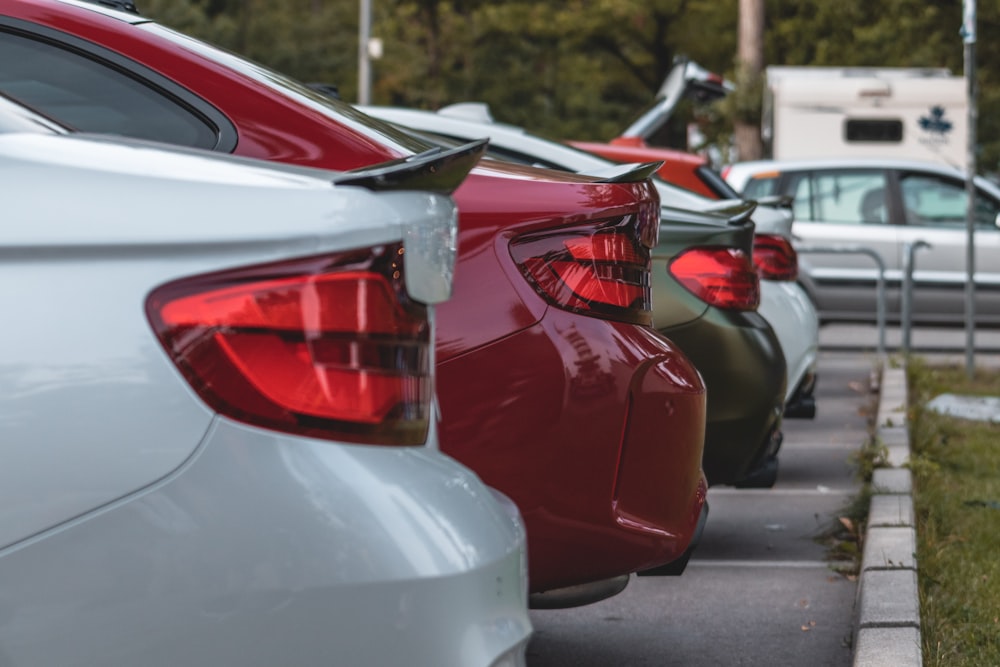 red and silver cars on road during daytime