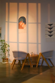 A happy customer placing a rubber protector on the bottom of a table leg in a cozy living room.