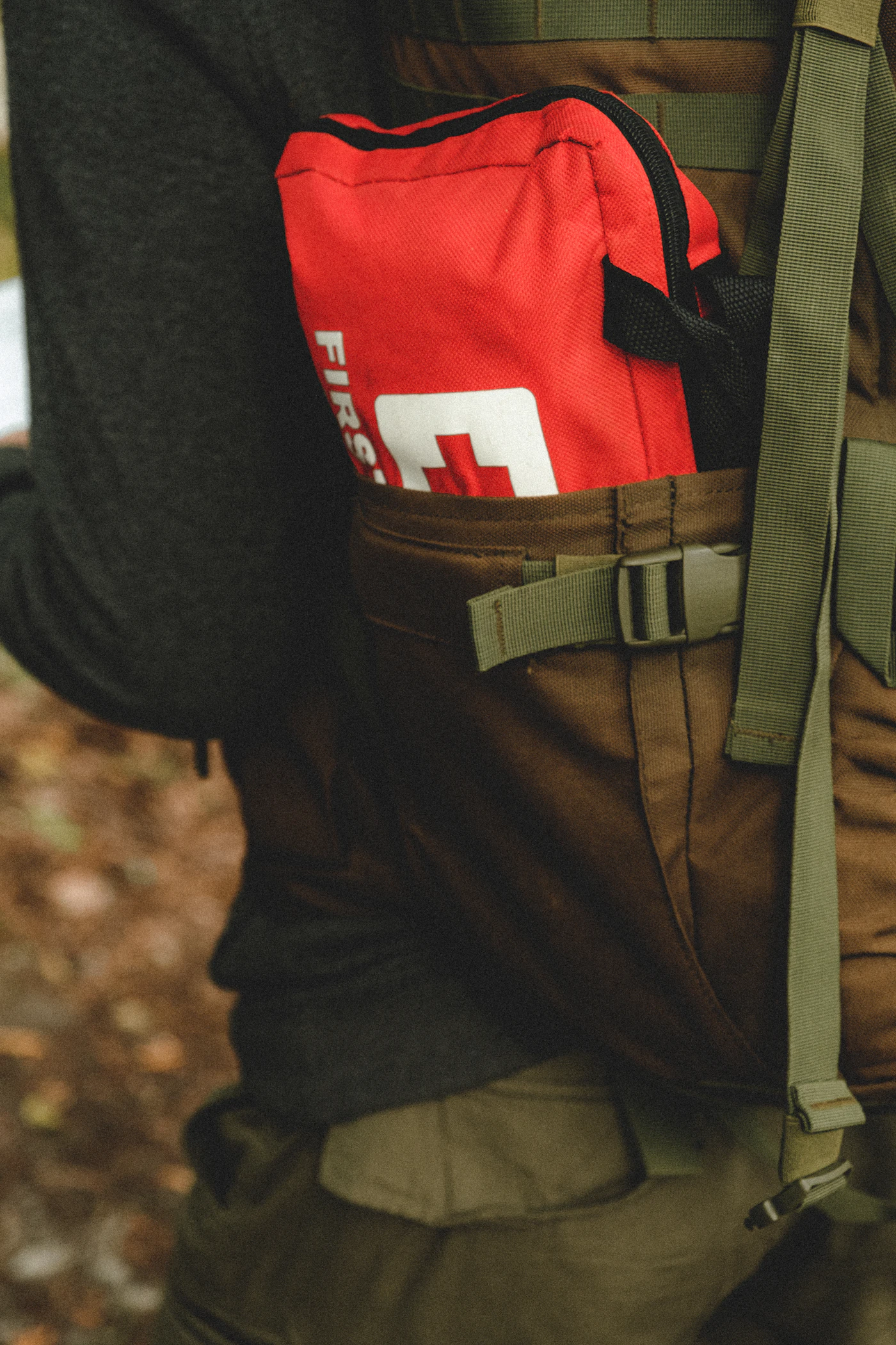 Person wearing a backpack packed with emergency supplies