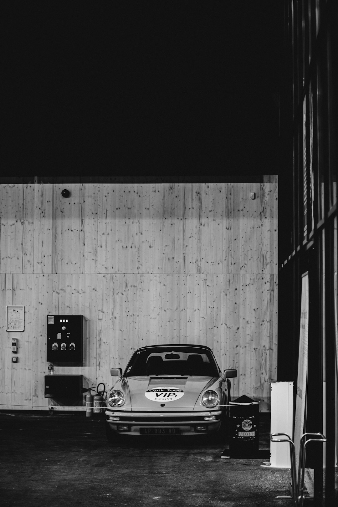 grayscale photo of car in a garage
