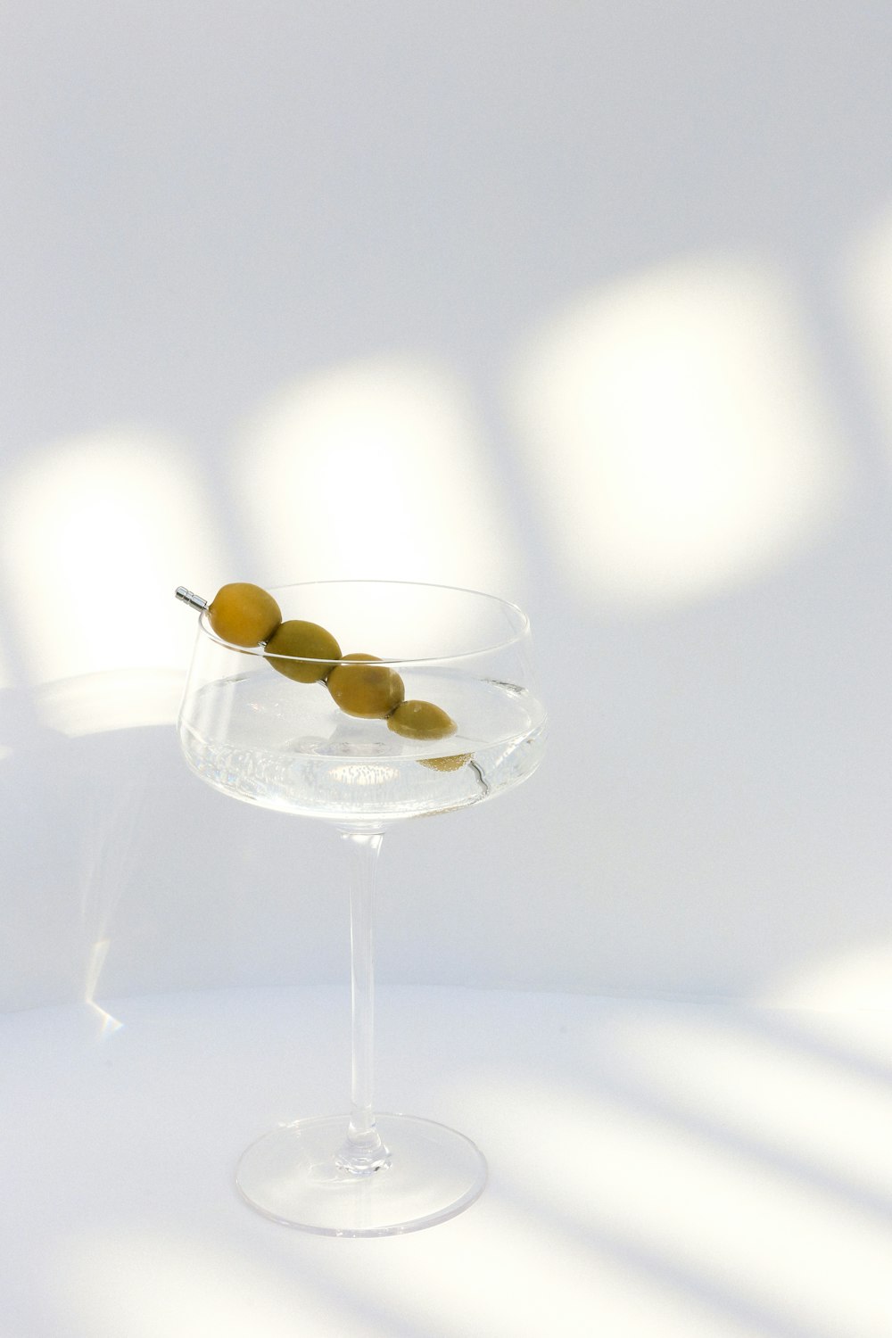 gold round coins on clear glass bowl