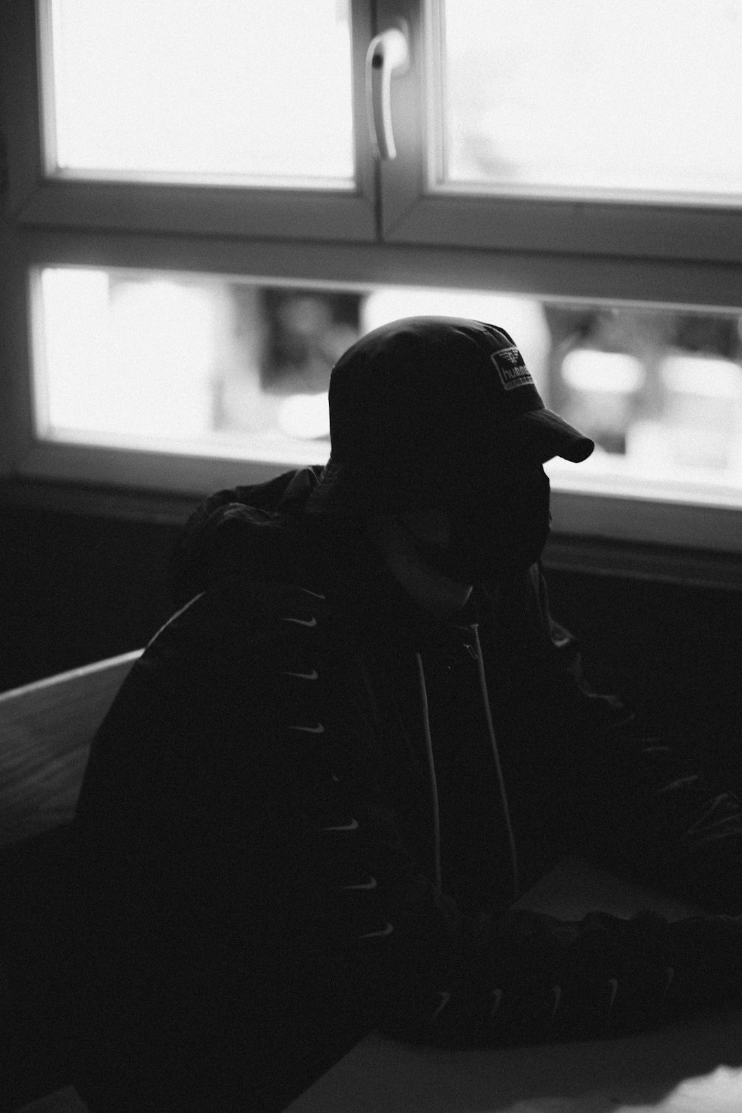 man in black hoodie wearing black headphones