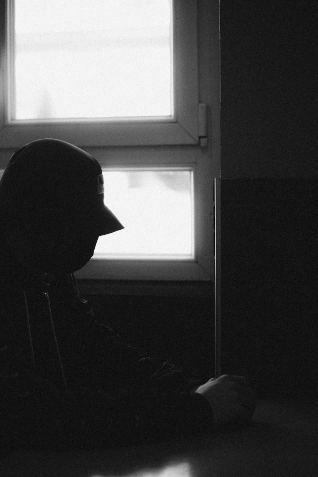 silhouette of person near window