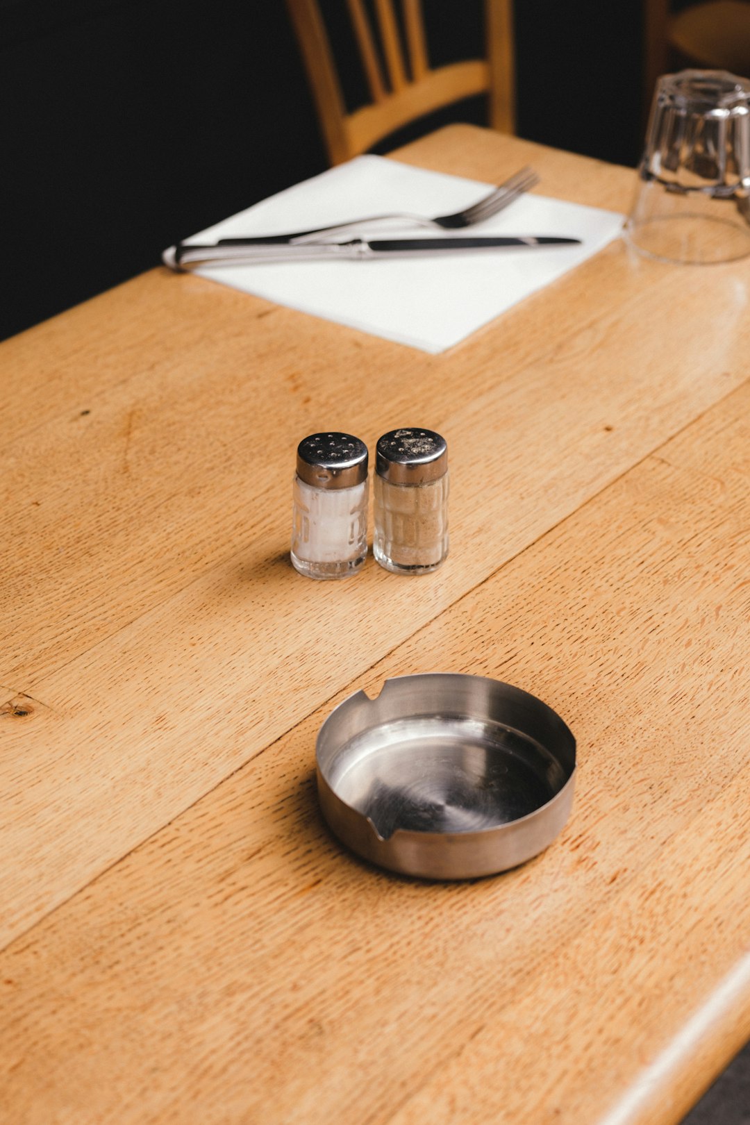 stainless steel round plate beside condiment shakers