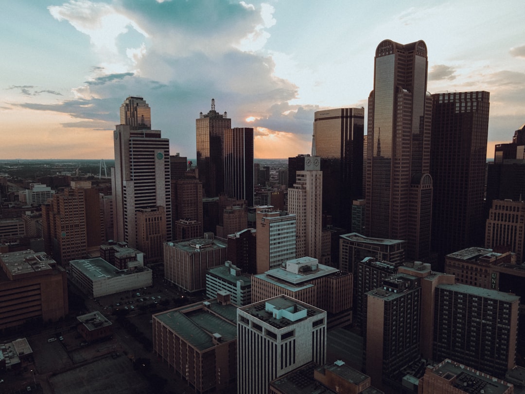 an aerial view of a city at sunset,