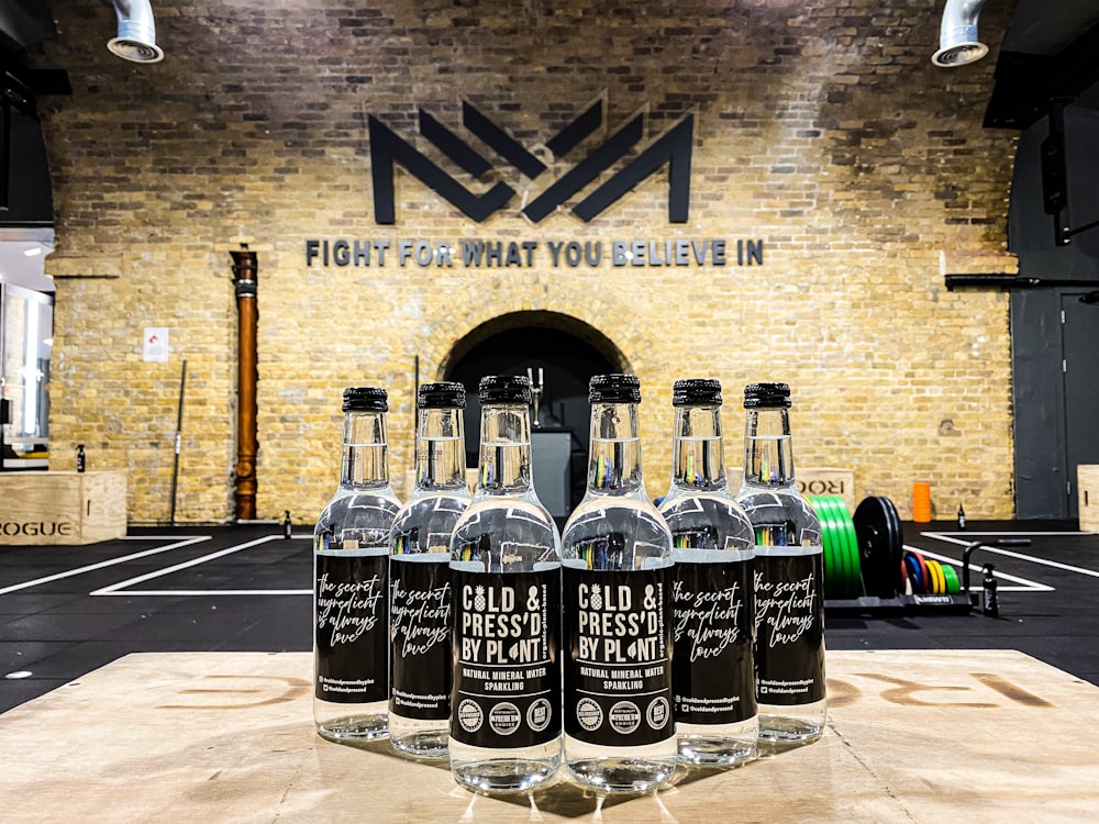 black and white labeled bottles on gray concrete floor