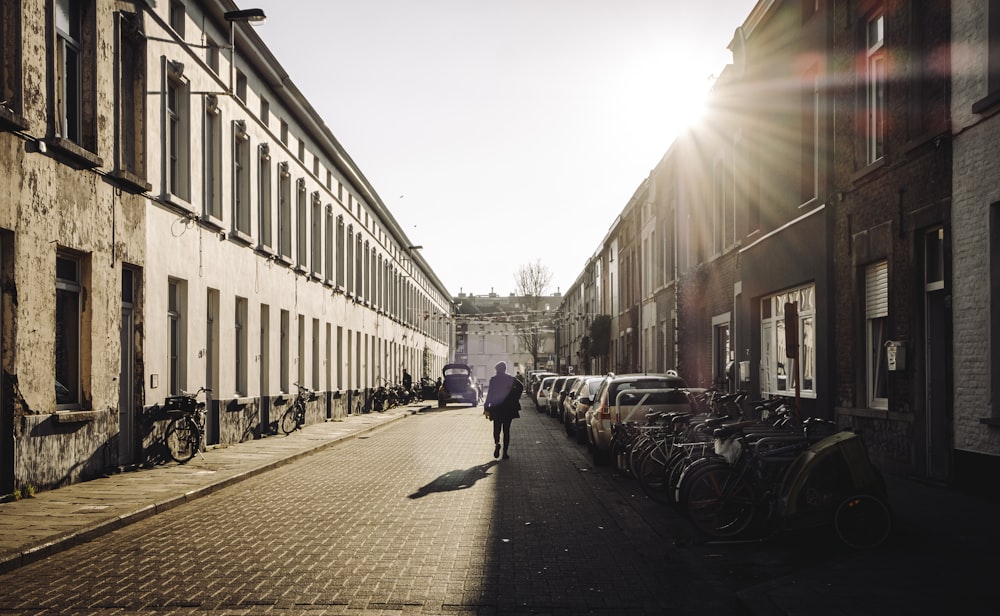 people walking on sidewalk near buildings during daytime