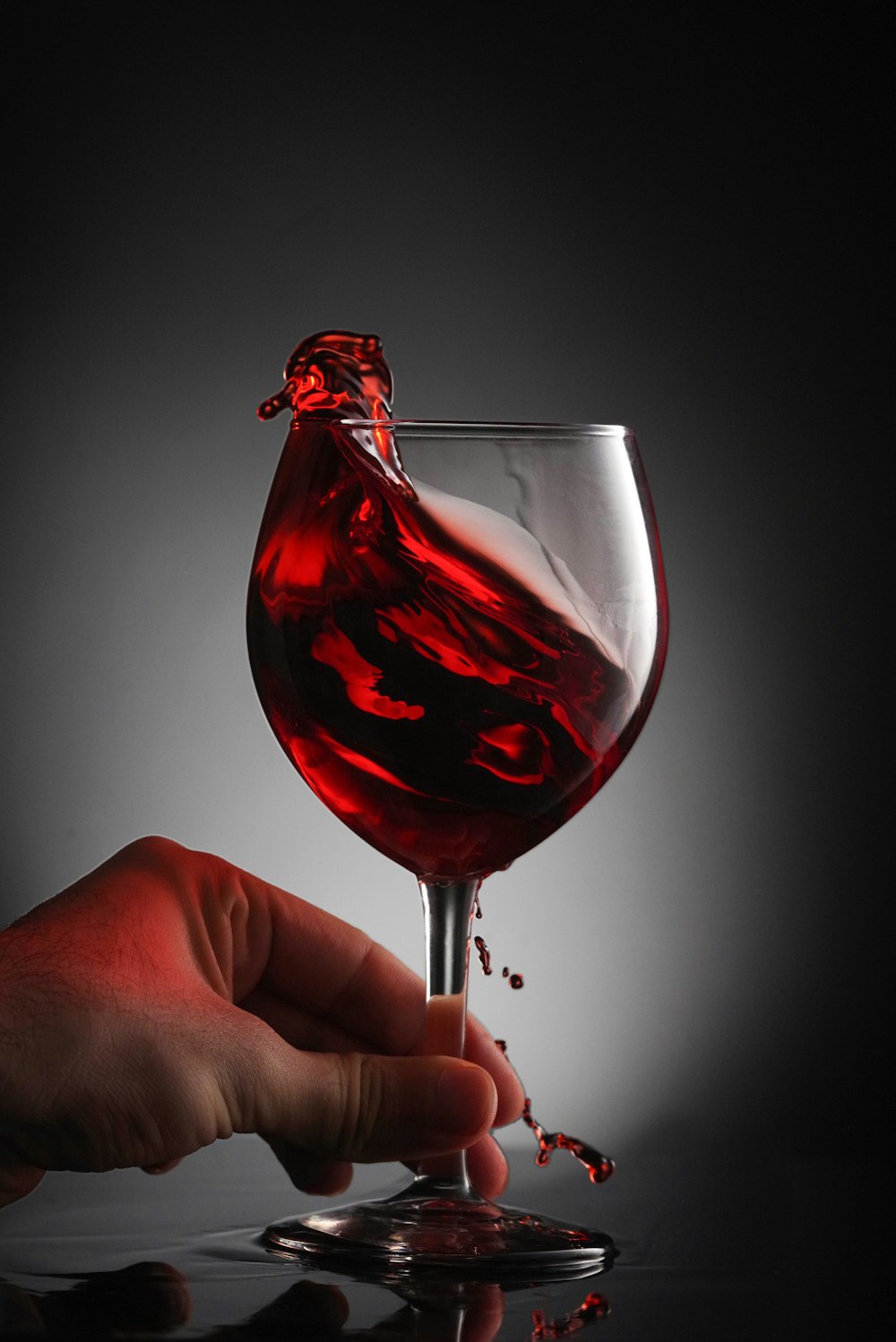 a glass of red wine being poured into it