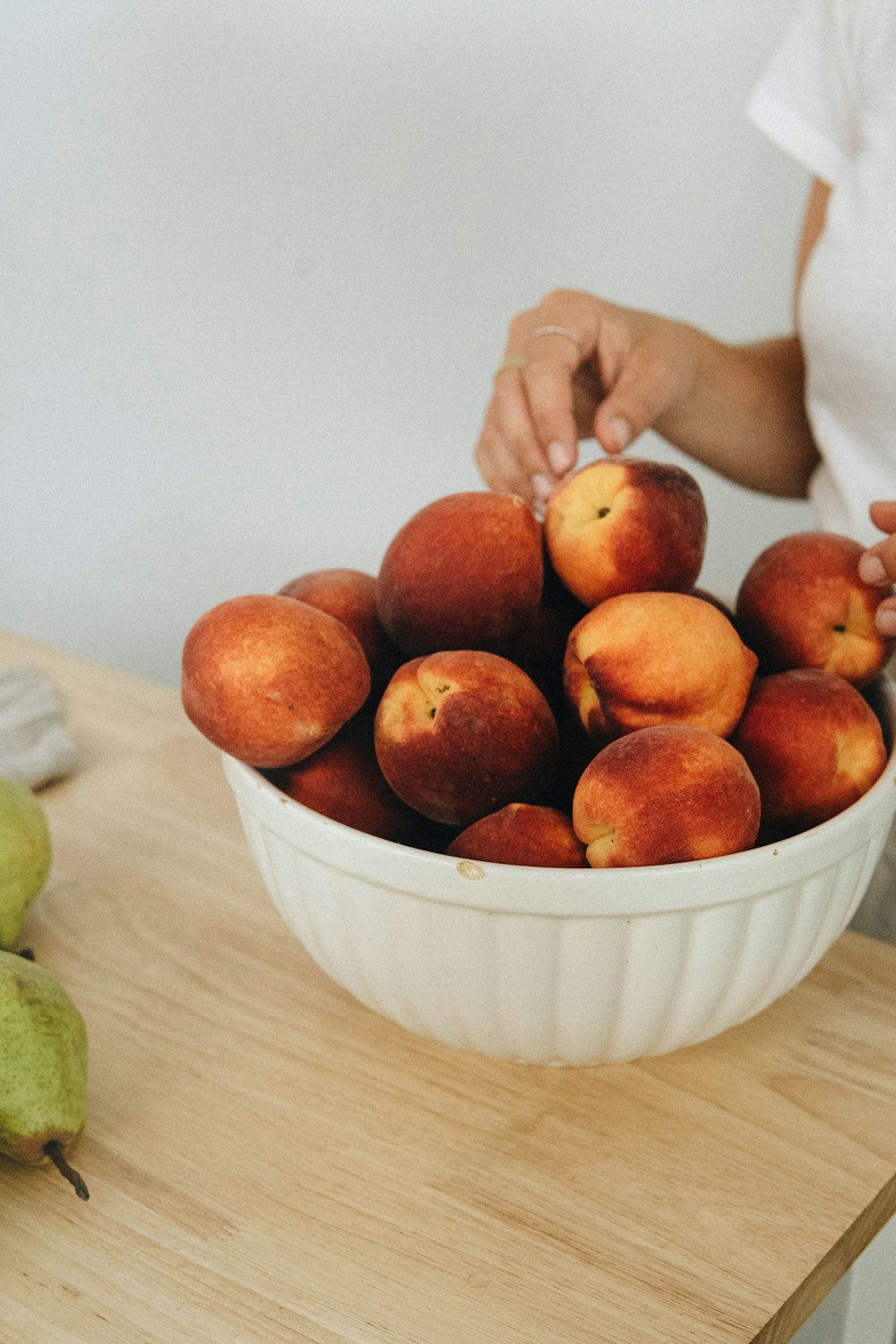 red apple fruit on white ceramic bowl