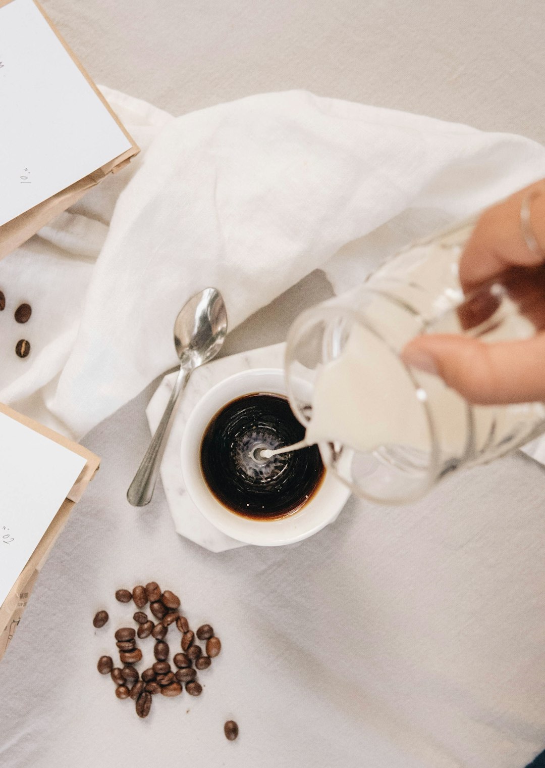 person holding white ceramic mug with coffee