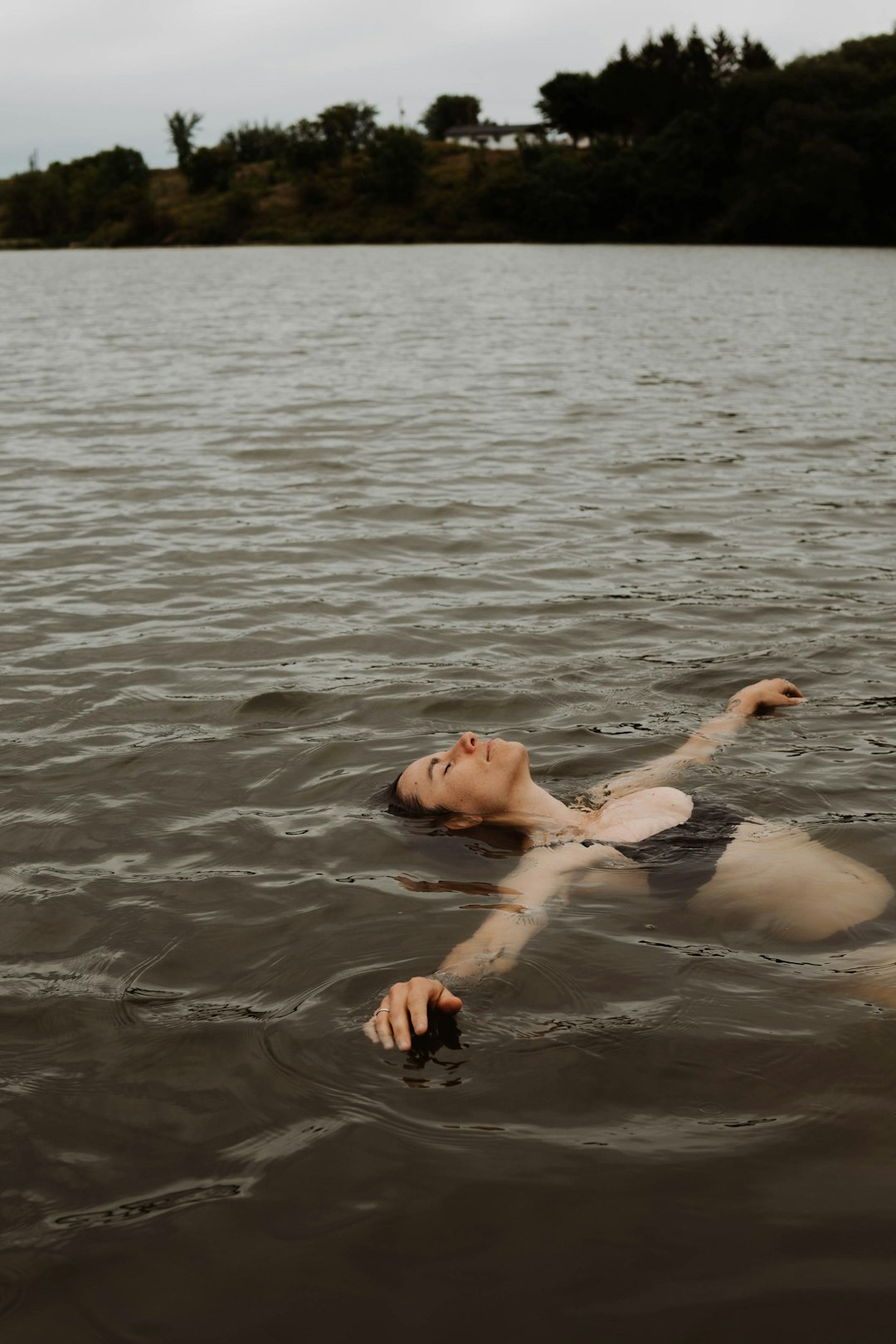 man and woman in water during daytime