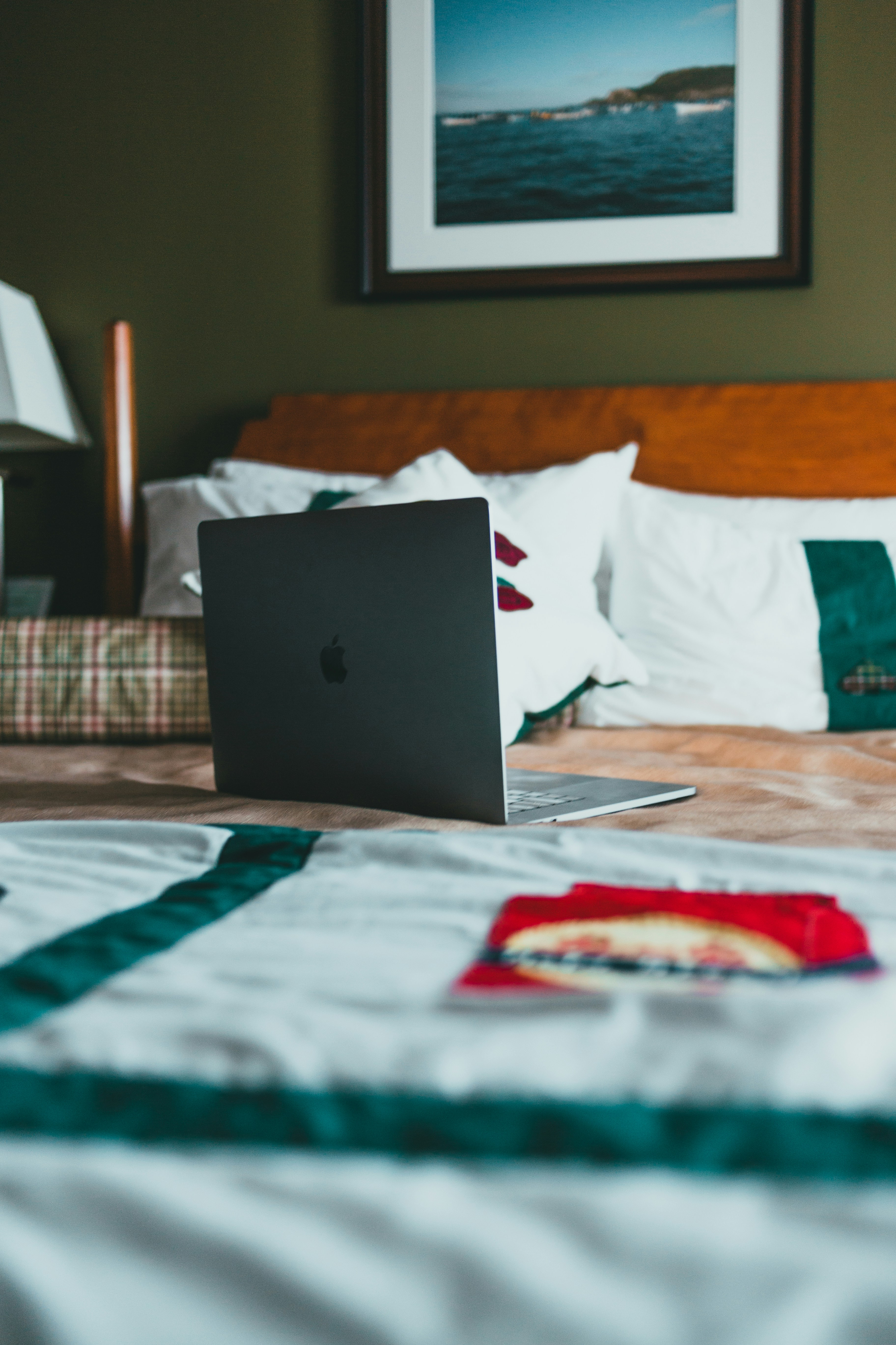 black laptop computer on bed