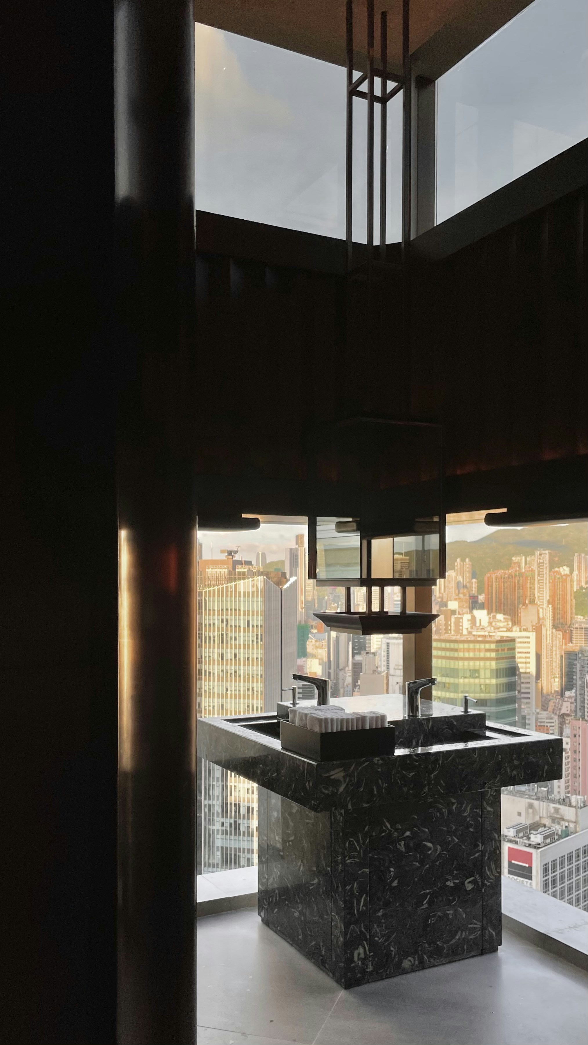 Beautifully designed bathroom overlooking the city during the golden hour.